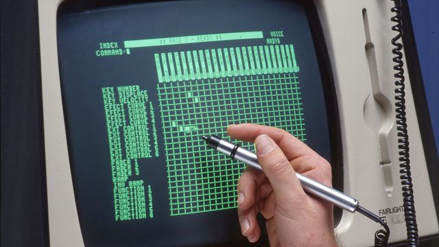 A light pen pointing at an old monitor